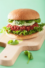 veggie beet and quinoa burger with avocado dressing