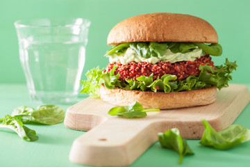 veggie beet and quinoa burger with avocado dressing