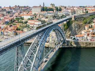 Fototapeta na wymiar View of Dom Luis I Bridge, city walls and historic district Ribeira from Mosteiro da Serra do Pilar in Gaia, Porto, Portugal