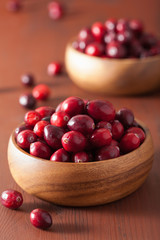 fresh cranberry in wooden bowls over rustic table