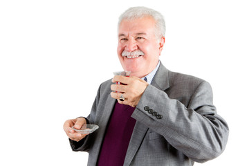 Smiling Senior Businessman with Tea Looking Out