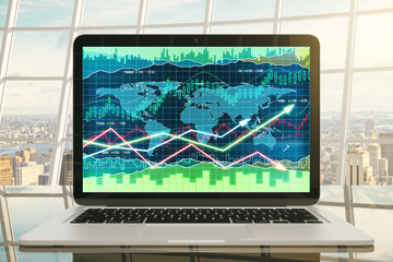 Business graph with glowing arrows on laptop screen on glassy ta