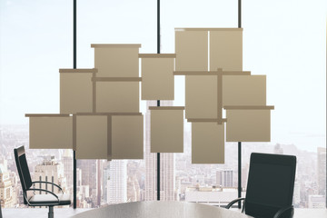 Blank paper posters on window of conference room with furniture,