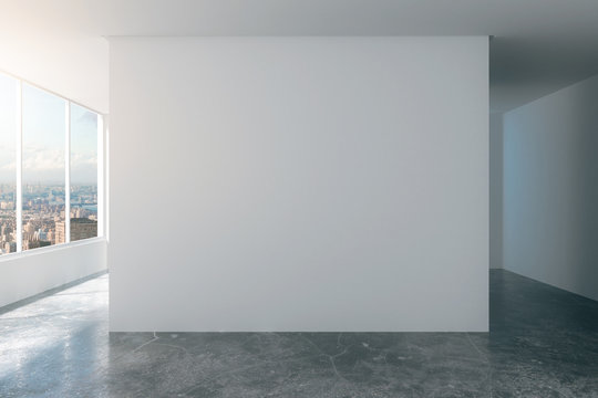 Empty loft room with white walls, city view and concrete floor