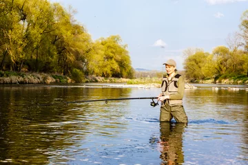 Foto op Aluminium woman fishing in the river in spring © Richard Semik