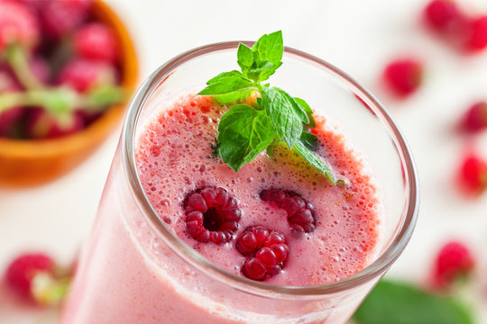 Fruit smoothie drink made of fresh raspberry and mint, close-up, macro