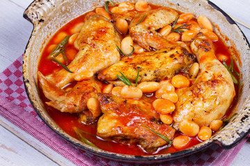 Chicken with white beans and rosemary in pan
