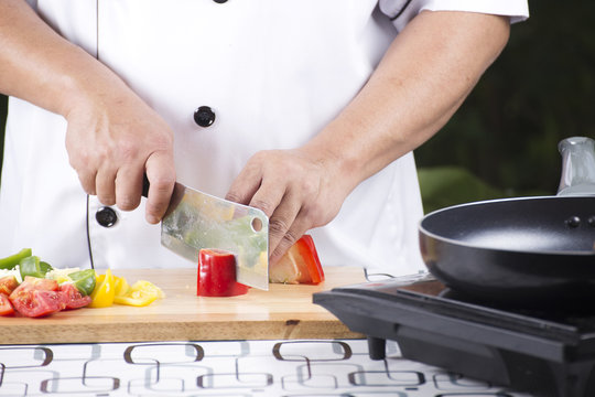 Chef cutting red bell pepper
