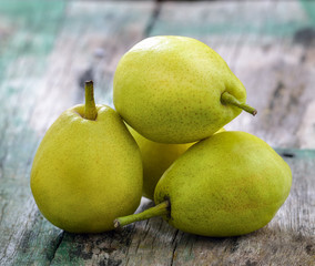 Green pears on a rustic wooden