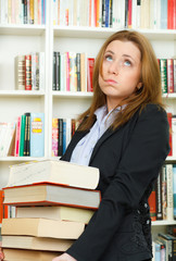 Young student in library with books