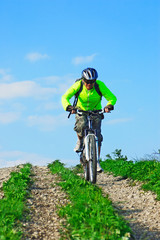 Fototapeta na wymiar Cyclist rides downhill from mountain