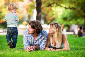 Young beautiful happy family at the park