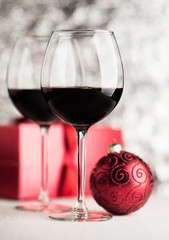 Wine and christmas ball on bright background