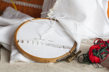 Openwork embroidery, incomplete work in progress and tools for embroidery