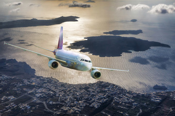 Fototapeta premium Airplane above Santorini island in Greece