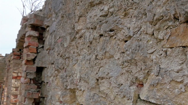 Part of the broken wall of the house. Pieces of bricks are destroyed from the house