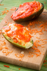 stuffed avocado on a cutting board