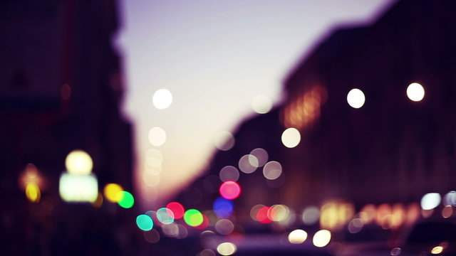 lights and colors of a sunset city in a urban context  defocuse and blurred near christmas time