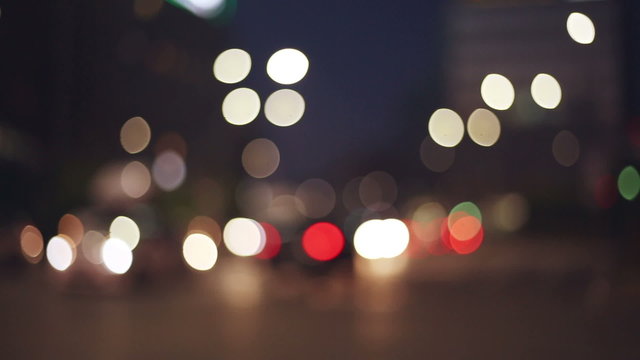   city lights in a blurred, bokeh and out of focus context with traffic in evening time 