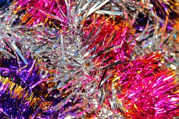 Festive multi-colored background with Christmas tinsel