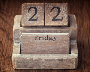 Grunge calendar showing Friday the twenty second on wood background