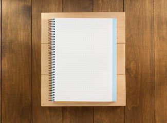 notebook and board on wood