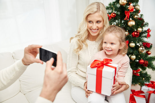 Family Taking Picture With Smartphone At Christmas