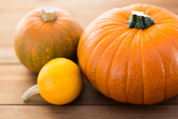 close up of pumpkins on wooden table at home