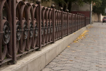 Steel fence near the sidewalk