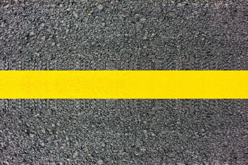 Fototapeta premium Asphalt surface of the road with a yellow line.