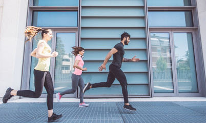 Group of friends making urban running and fitness