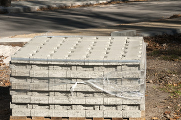 Pallet stacked with new cement paving slabs closeup