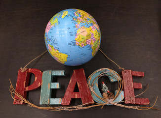 peace wood text with christmas tree and earth globe