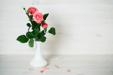 Pink roses on a wooden background