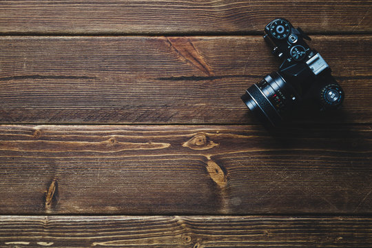 Old camera on wooden table