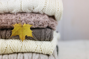 Fototapeta na wymiar stack of sweaters knitted autumn concept