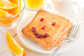 Smile face with jam on toast