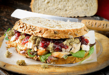 Turkey, chicken sandwich with stuffing and cranberry sauce.
