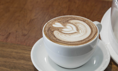 Close up white cup of Coffee, latte on the wooden table