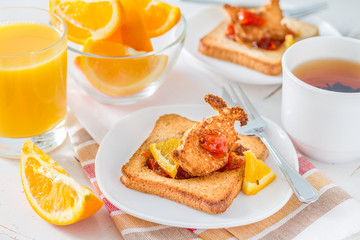 Bunny shaped toast with jam, juice and tea