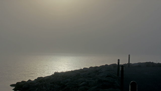The fod or small port where there is fog. Sun is still shining but the fogs make the area darker