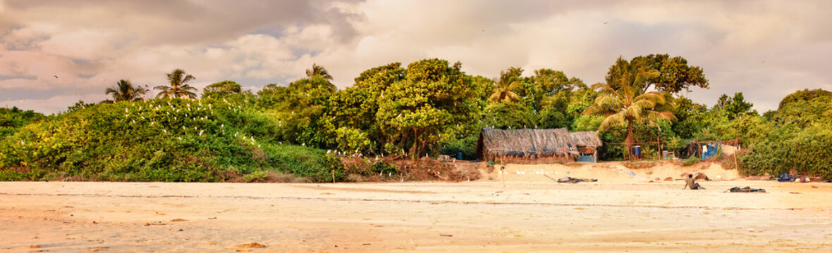 Tropical beach in ebb time on sunset background, Mobor Beach, South Goa, India.