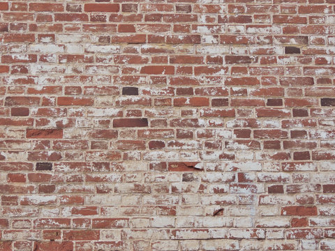 Old red rough brick wall with cement and peeling paint texture background backdrop vintage loft style.  Home or office design loft style interior.	