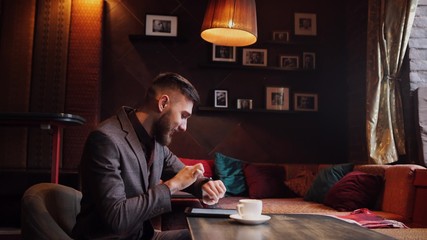 Man using an advanced personal e-cigarette and used tablet
