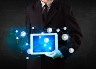 Young person holding talbet with communication technology concep