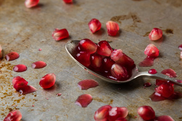 pomegranate seeds in a spoon
