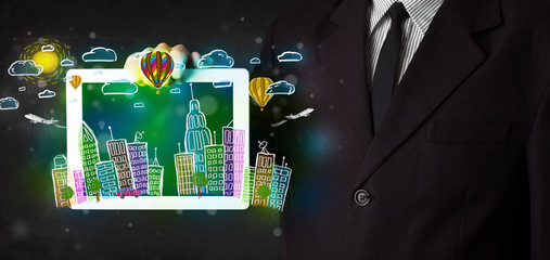 Young person showing tablet with hand drawn cityscape