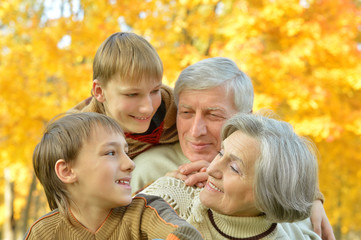 Family relax in autumn park