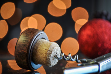 Corkscrew and corks on bokeh  background and christmas balls