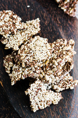 crackers from flax seed, sesame, sunflower and spices on a dark